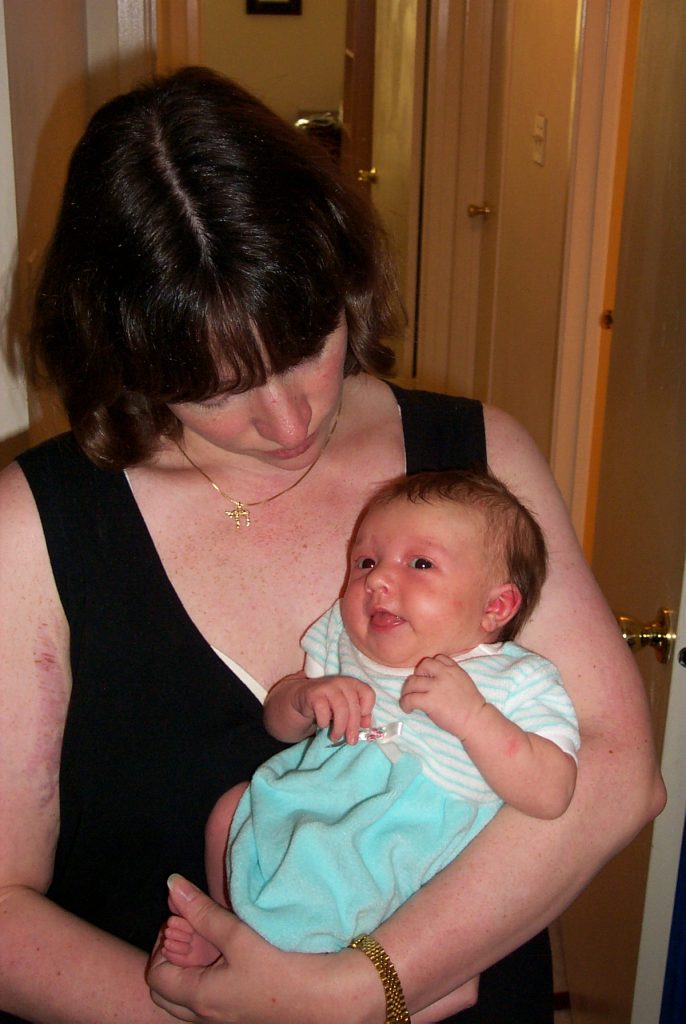 Mama holding Jenya in Stella’s dress (3 weeks old)