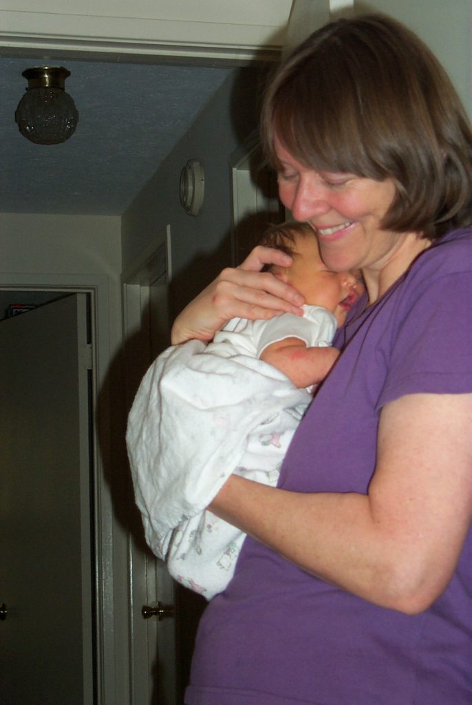 Grandma Susan snuggling Jenya, 4 days old